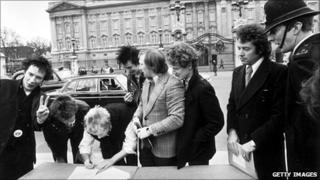 The Sex Pistols sign a record contract outside Buckingham Palace in March 1977
