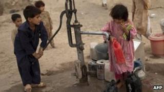 Pakistani children pump water from a well in the capital, Islamabad - 21 June 2010