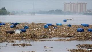 Barrels of chemicals float in the Songahua river in Jilin on 28 July 2010