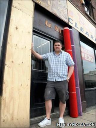 Jon Riley outside his burnt shop front
