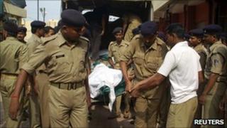 Police carry the body of a wounded colleague in Chhattisgarh in June
