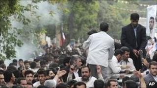 Smoke near the car in which Mahmoud Ahmadinejad (r) was travelling to Hamedan 4 August, 2010