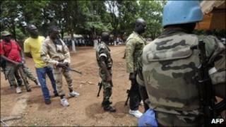 Former New Forces soldiers arrive to hand in weapons to peacekeepers in June 2010
