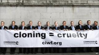 Activists wearing masks of Prime Minister David Cameron