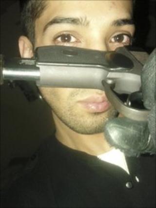 Ali Mahmood posing with gun