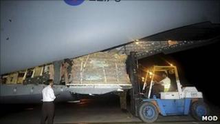 Forklift truck loads tents on to C17 aircraft