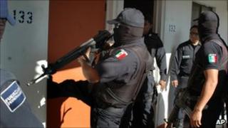 Federal police officer kicks a door open while looking for his commander