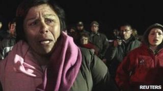 A relative of a miner waits outside of San Jose mine, Chile, August 8, 2010