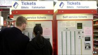 Commuters at rail ticket machines