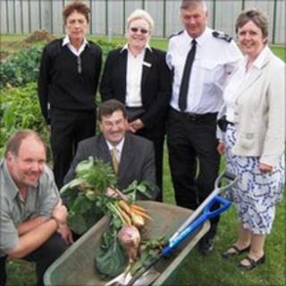 Home Affairs Minister Adrian Earnshaw MHK (centre) with prison staff