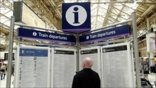 A passenger inspects a train timetable