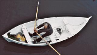 Poet Gerry Loose rowing a boat