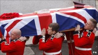 Stephen Monkhouse' coffin being carried