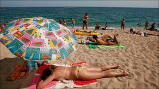 Holidaymakers on a beach in Spain