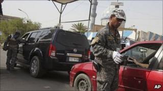 Police officers at a Baghdad checkpoint, file image