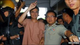 Korkaew Pikulthong, one of the leaders of the red-shirt movement, arrives for a hearing at Bangkok Criminal Court