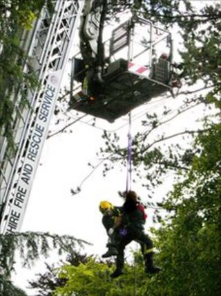 A paramedic with the injured tree surgeon