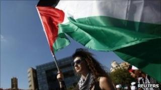 A protester carries a Palestinian flag outside the UN in Beirut. June 27, 2010