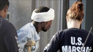 Police escort a Somali national into a federal court