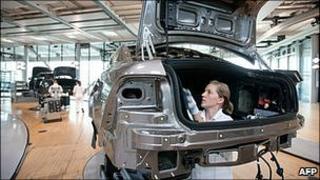 Worker on German carmaker Volkswagen's production line