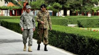 Gen David Petraeus talks with Pakistan Chief of Army Staff Gen Ashfaq Kayani in the gardens of the Afghan Presidential Palace in Kabul (file picture 9 August)