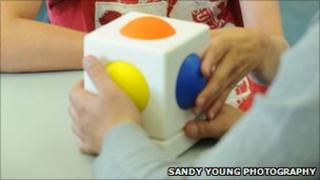 Child playing with a 'Skoog' musical cube