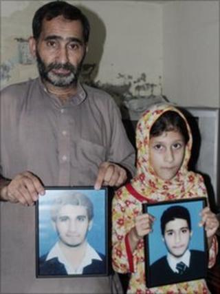 The portraits of the two brothers are shown by their father Sajjad Butt and sister Momina Butt at their home in Sialkot on Sunday, 22 August, 2010