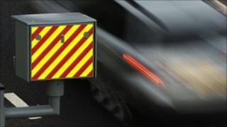 Car passing a speed camera - file photo