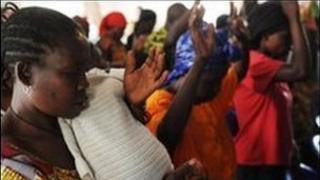 Congolese rape victims raise their hands as they pray at a chapel inside the Heal Africa clinic in Goma on August 9, 2009