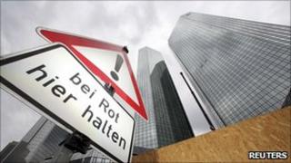 Road sign saying "stop here on red light" outside Deutsche Bank's headquarters in Frankfurt