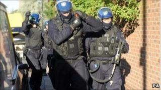 Police prepare to raid a property as part of Operation Razorback