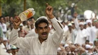 A farmer gestures at a protest rally in New Delhi, India, Thursday, Aug. 26, 2010