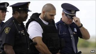 Police escorting Elias Abuelazam at an airport in Michigan