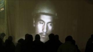 Families watch miners on video in Copiapo, 27/08