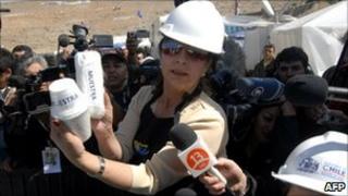 The person in charge of the new food rations to be delivered to the miners shows a sample of their meal, Chile, 1 September 2010
