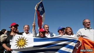 Andes plane crash survivors Ramon Sabella, Gustavo Zerbino and Pedro Algorta pose with relatives of the trapped Chilean miners