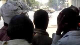 People watching a tank in a Mogadishu street