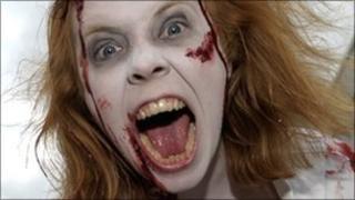 A woman dressed up as a zombie participates in the "Zombie walk" through central Stockholm