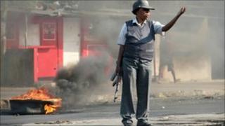 Policewoman gestures during food riots (2 September)