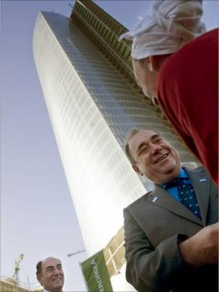 Scottish First Minister Alex Salmond (2R) talks to a Basque dancer next to President of Iberdrola power company Ignacio Galan (L) in front of the new Iberdrola Tower