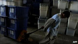 An Afghan election worker sort ballot boxes in Kabul