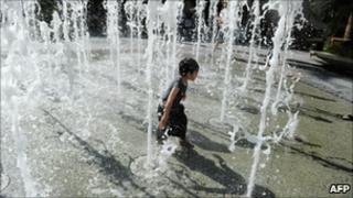 A boy cools down in a Los Angeles fountain