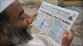 Muslim man reading newspaper with Ayodhya headlines