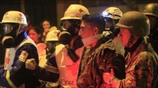 Red Cross medics escort an army soldier in Quito
