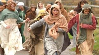 Women fleeing during a re-enactment of a 15th Century battle in Wales