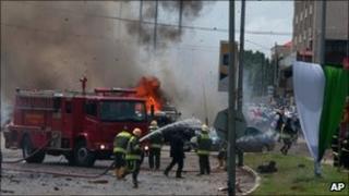 Fire-fighters after the Abuja blasts