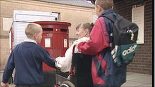 Two young carers pushing a woman in a wheelchair