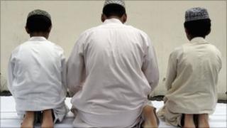 Muslim men praying
