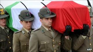Italian Alpine troops carry the coffin of one of two comrades killed in Afghanistan on 17 May