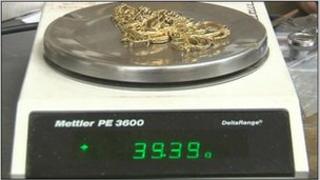 Gold being weighed